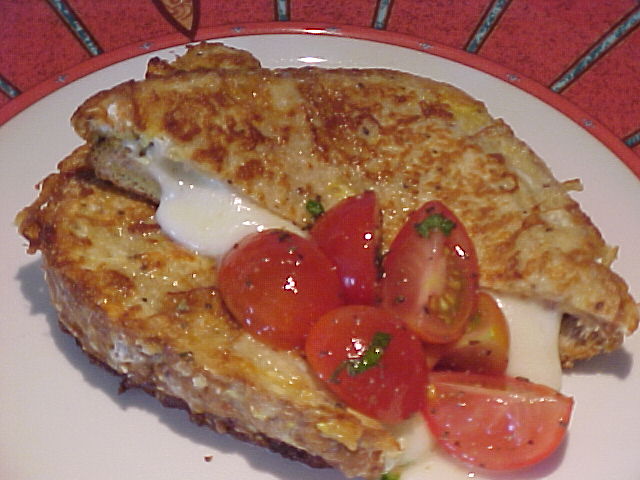 Pan‑fried mozzarella sandwich with basil and cherry tomatoes